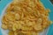 plate full of yellow dried cornflakes