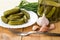 Plate with gherkins, fork, garlic and jar with cucumbers