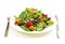 Plate of green salad on white background