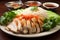 Plate of Hainanese chicken rice with vegetables and sauce on wooden table
