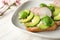 Plate with healthy toasts on wooden table, closeup