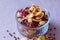 Plate of homemade muesli with cornflakes, freeze dried strawberry, walnuts, chocolate balls, pumpkin seeds