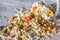 Plate of homemade muesli with pumpkin seeds, flower dust, candied fruit, freeze dried apricot