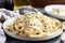 plate of homemade pasta with creamy alfredo sauce and shaved parmesan