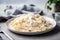 plate of homemade pasta with creamy alfredo sauce and shaved parmesan