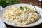 plate of homemade pasta with creamy alfredo sauce and shaved parmesan