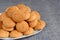 Plate of Italian Amaretti cookies on a blue placemat