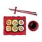 Plate of Japanese sushi, rolls, chosticks and soy sauce bowl