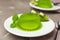 Plate with kiwi jelly and mint served on beige table