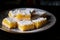 A plate of lemon bars with a powdered sugar topping