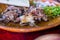 Plate of Mexican chopped lamb meat on colorful tablecloth