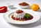 a plate of mexican food, chile en nogada surrounded by ingredients on white background