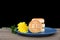 A plate of moon cakes and a chrysanthemum on a table with a dark