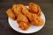Plate of Mouthwatering Golden Brown Crunchy Fried Chickens on Wooden Table