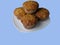 Plate of muffins on blue