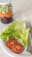 Plate of nutritious salad with lettuce and tomato and a glass with grated beetroot and carrot