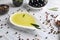 Plate with olive oil and pepper corns on light background