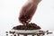 A plate overflowing with coffee beans on a white background