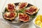 Plate of Oysters Kilpatrick with Napkin and Lemon