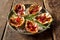 Plate of Oysters Kilpatrick on Rustic Wooden Table