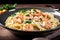 plate of pasta with shrimps in creamy alfredo sauce