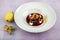 Plate of pears poached in red wine, dessert decorated with on wooden table
