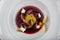 Plate of pears poached in red wine, dessert decorated with on wooden table