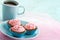 Plate with pink chocolate pralines and cup of coffee