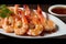 plate of piping hot tiger shrimp prawns with tangy spicy sauce