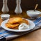 A plate of Polish potato pancakes served with sour cream.