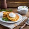 A plate of Polish potato pancakes served with sour cream.