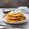 A plate of Polish potato pancakes served with sour cream.