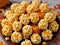 A Plate Of Popcorn And Pumpkins On A Table. Generative AI