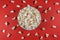 Plate of popcorn on a red colored background. Cinema and entertainment concept. Top view