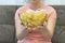 A plate of potato chips and a centimeter tape in the girl`s hands. Junk food. The concept of struggle against excess weight.