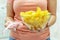 A plate of potato chips and a centimeter tape in the girl`s hands. Junk food. The concept of struggle against excess weight.