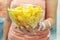 A plate of potato chips and a centimeter tape in the girl`s hands. Junk food. The concept of struggle against excess weight.