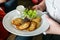 A plate of potato pancakes in the hands of a waiter