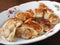 A plate of potstickers