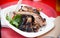 Plate with prepared beef steak and salad