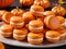 A Plate Of Pumpkin Macaroes With A Pumpkin In The Background. Generative AI