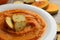 Plate of pumpkin puree with croutons on gray background