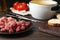 Plate with raw meat fondue pieces on table