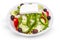 Plate of real Greek salad isolated on white.