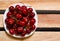 Plate with red cherries on wooden plates, top view, space for text