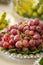 Plate of red grapes in a cluster on a table being catered for a wedding ceremony