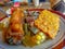 A plate of rice with a side dish of fried tempe plus tamarind vegetables