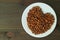 Plate of Roasted Barley Grains for Japanese Mugicha or Barley Tea in Heart Shaped on Wooden Table