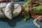 Plate with roasted sardine on bread and salad with lettuce and roasted red pepper