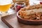 Plate with rolled thin pancakes and walnuts on table, closeup